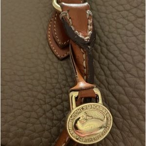 A hand bag with straps Dooney & Burke